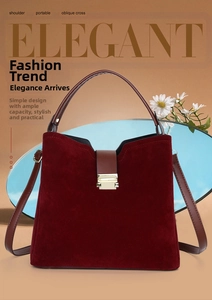 Detail of wine red suede handbag featuring brown leather handle and gold metal clasp