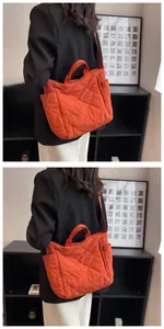 Close-up of burnt orange quilted tote bag featuring diamond pattern and side pocket