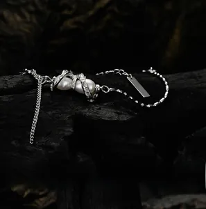 Detail view of S925 silver pearl bracelet with zircons on a dark textured background