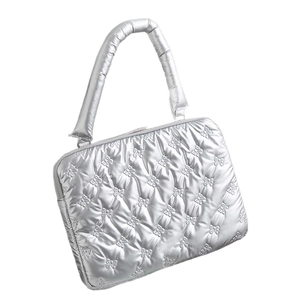 Quilted silver laptop bag with padded handles and decorative bow stitching pattern