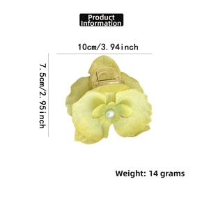 Detail view of yellow-green orchid hair claw with white pearl, sized 10cm by 7.5cm