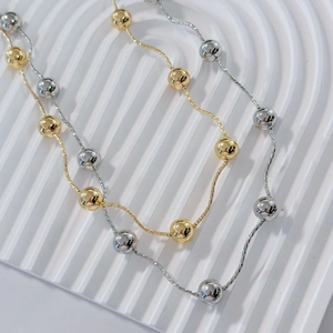 Minimalist 18k gold plated bead chain necklace in gold and silver finish on white background