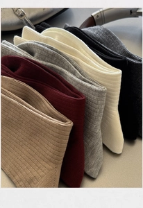 Detailed close-up of ribbed combed cotton socks in various neutral earthy colors