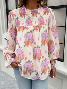 Detail of ruffle high neck and smocked chest on beige floral lantern sleeve shirt