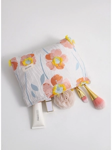 Floral embroidered makeup bag in cream fabric with yellow tassels and large capacity