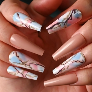 Detail of nude long coffin press-on nails with blue and pink marble texture and gold glitter