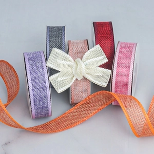 Detailed close-up of colorful faux linen ribbons with wavy edges for festive DIY crafts