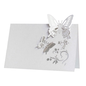 Detailed laser-cut wedding place card featuring elegant white 3D butterfly and floral patterns