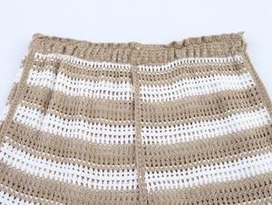 Detail of light brown striped crochet shorts featuring hollow out knit and elastic waist