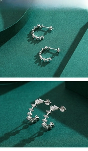 Macro detail of S925 silver C-shape earrings with inlaid baguette-cut cubic zirconia