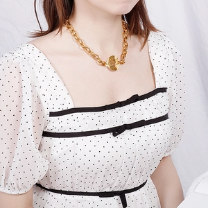 Punk gold chunky chain necklace featuring a hollow tree of life pendant on a female model