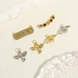 6-piece 18K gold plated charms set including FAMILIA bar and winged snitch pendants