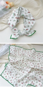 Detail of white cotton linen square scarf with red floral print and green stitched edges