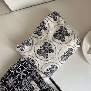 Artistic embroidered canvas makeup bags featuring butterfly and floral patterns