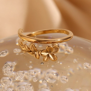 Macro view of 18K gold plated double layer flower and leaf open ring on glass bead