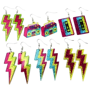 Glittery neon lightning and retro cassette earrings collection on white background