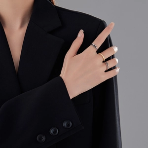 Three-layer detachable feather rings in mixed gold and silver tones worn on hand