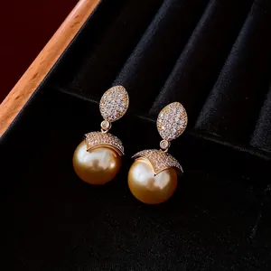 Elegant 18k gold plated pearl earrings with leaf design in a velvet jewelry box