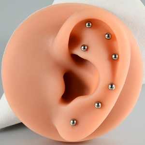 G23 Titanium internally threaded ball stud earrings shown on a silicone ear model