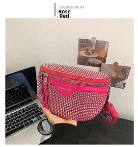 Detail of rose red rhinestone crossbody bag with branded strap and matching mini pouch