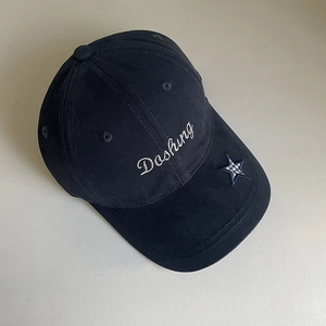 Detail of navy cotton baseball cap featuring Dashing embroidery and star patch