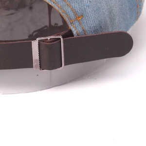 Light blue denim baseball cap with brown leather back strap and silver metal buckle