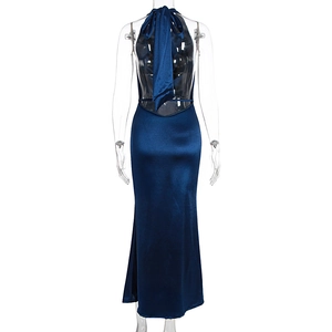 Detail of the back of a dark blue satin halter dress featuring a large bow tie