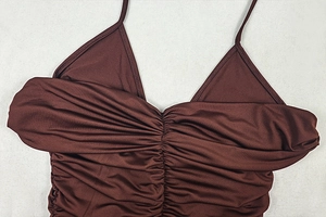 Detail of the gathered neckline and spaghetti straps on a chocolate brown satin dress