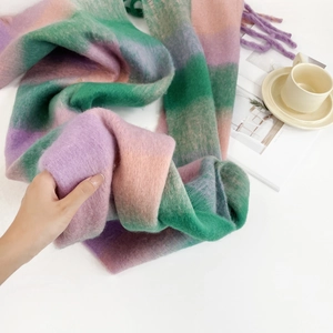 Detailed texture of thick mohair scarf featuring pink and purple gradient plaid patterns