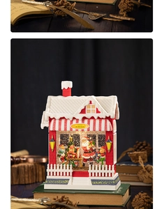Close-up of Santa's Workshop musical snow globe lantern with warm glowing lights
