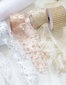 Detail of sheer chiffon ribbons with glittering snowflakes and sequins for Christmas trees