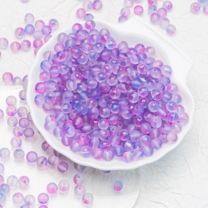 Macro view of gradient purple and blue frosted glass beads for DIY jewelry making