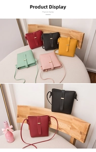 Detailed close-up of a stylish minimalist bucket bag showing buckle and strap details