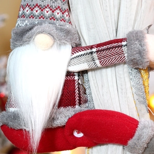 Christmas gnome curtain buckle with striped hat and faux fur beard on white curtain