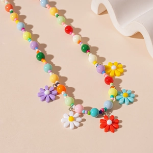 Detailed close-up of colorful daisy flower pendants and acrylic beads on the choker