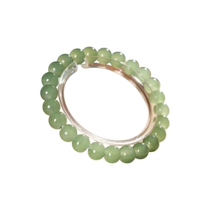 Elegant light green beaded bracelet in jade chalcedony on a round display stand