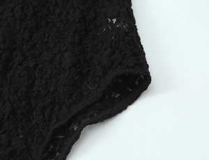 Detailed macro view of black floral lace fabric with fine stitching for lingerie sets