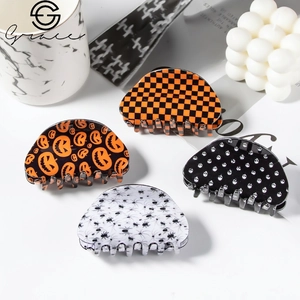 Set of 4 Halloween hair claws with pumpkin, spider web, and skull patterns