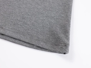 Detailed close-up of grey V-neck t-shirt hem featuring professional double-needle stitching