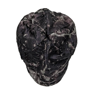 Top view of distressed knit beanie with grey camouflage marble pattern and ripped details