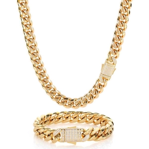 Close-up of golden Cuban link necklace and bracelet set with crystal encrusted clasp