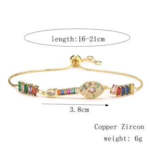 Detail view of golden evil eye bracelet with colorful zircons and size measurements