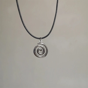 Silver swirl sun star pendant necklace with black cord shown on a clean background