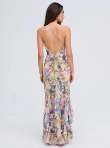 Back view of floral maxi dress with cross straps and ruffle hem detail for beach vacation