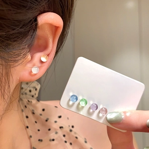 Colorful resin ball stud earrings set in various pastel shades shown on a model