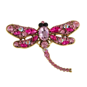 Vintage gold dragonfly brooch with pink crystal embellishments and intricate rhinestone wings