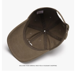 Detail of cotton baseball cap interior featuring seam taping and adjustable metal buckle