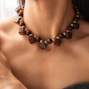 Vintage bohemian necklace with brown wood beads and leopard print acrylic square charms
