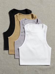 Flat lay of four slim fit ribbed knit yoga tanks in black, khaki, purple and white