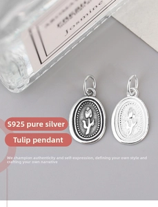 Macro shot of oval S925 sterling silver tulip pendants in polished and vintage finishes